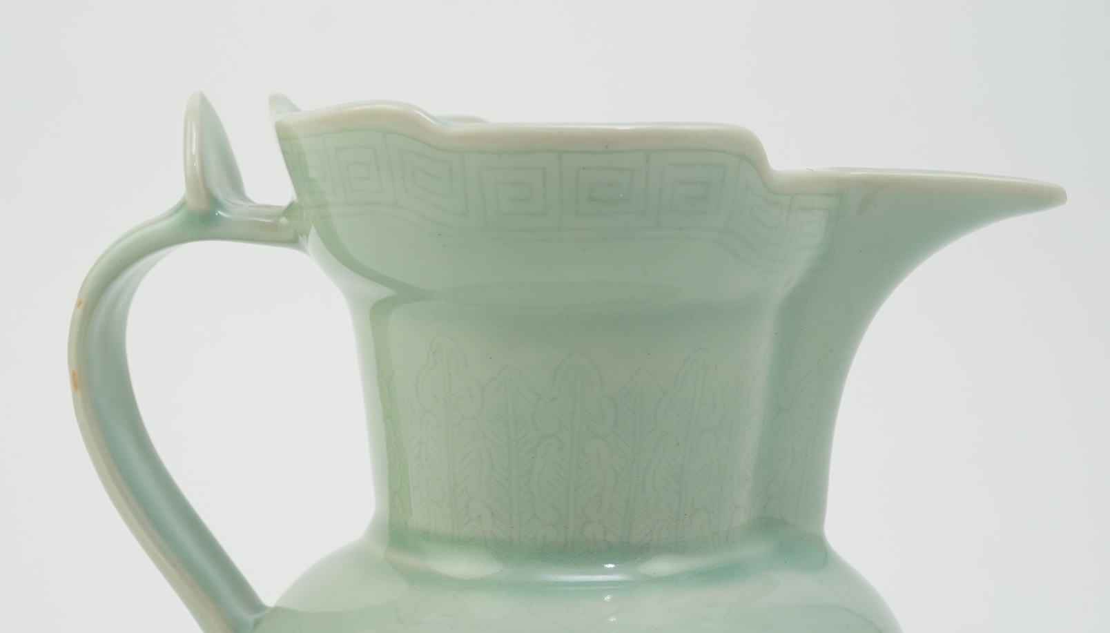 A Chinese incised celadon glazed monks cap ewer, Qianlong seal mark but later, 17cm